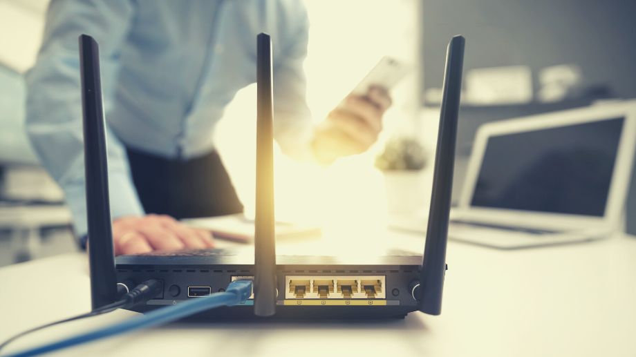 A man troubleshooting a router
